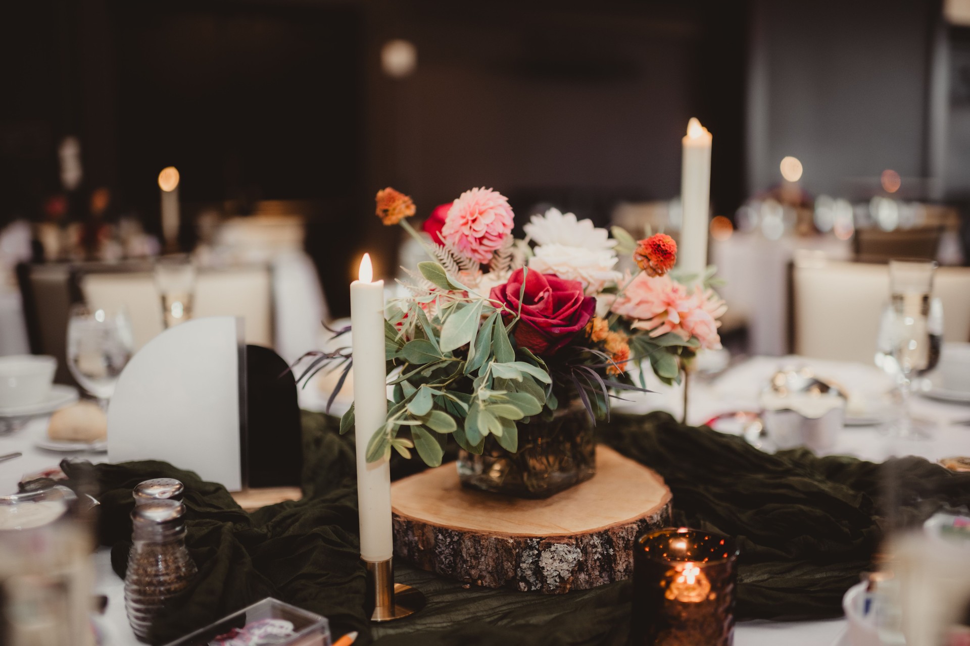 Wedding reception table with candles and flower centerpiece